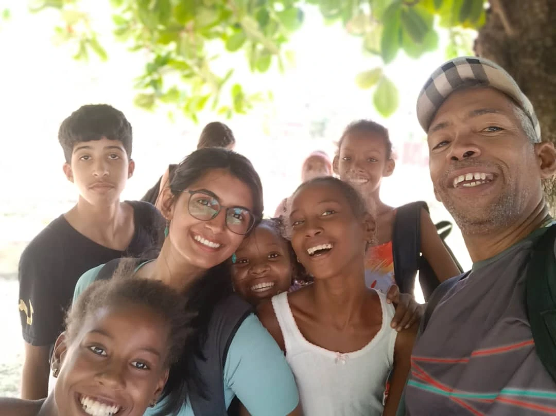 Children and adults smiling together outdoors in Cuba