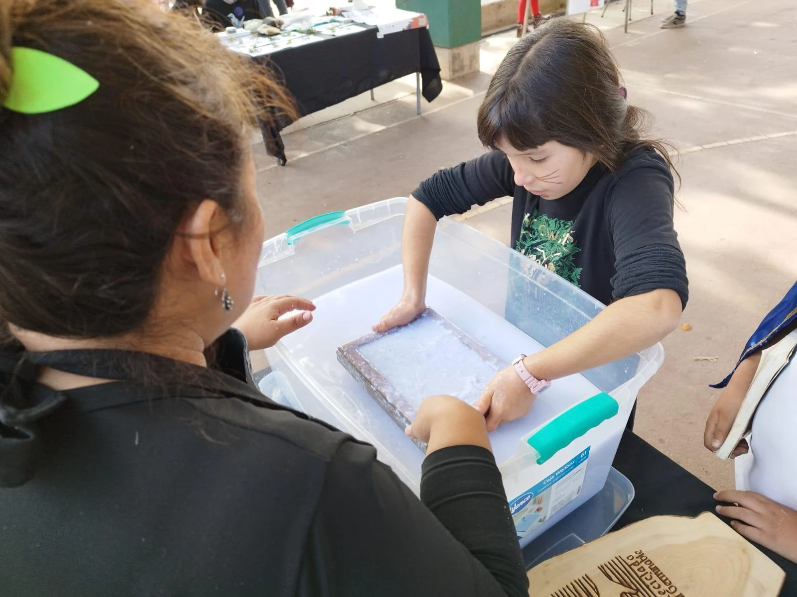 Children making recycled paper in an illustrative workshop photograph
